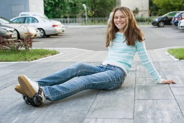 Chica adolescente en las ruedas de los rodillos, adaptado a las zapatillas de deporte —  Fotos de Stock