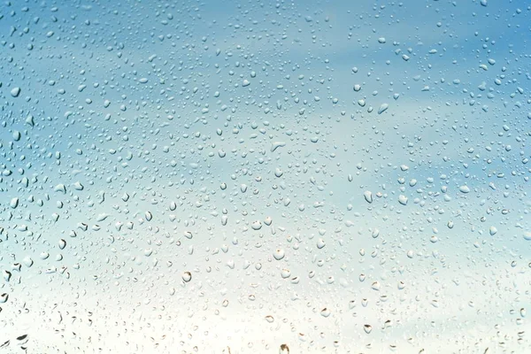 Background image - abstract rain drops on a sunny window, textures. — Stock Photo, Image