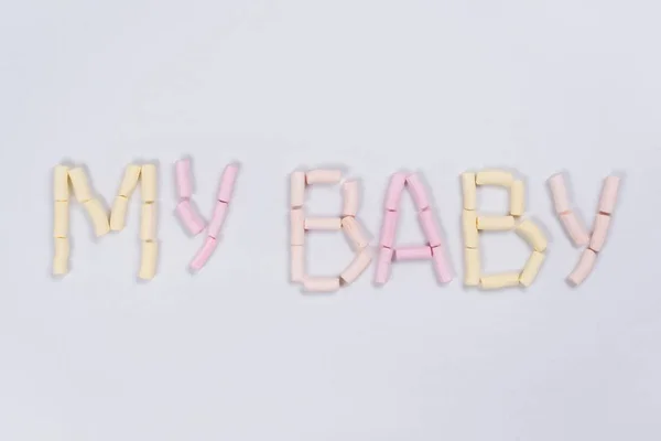 The word my baby is written by a pastel marshmallow on a white background. Backgrounds, textures. — Stock Photo, Image