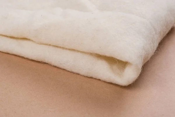 Fundo branco de material de lã natural não tecido — Fotografia de Stock