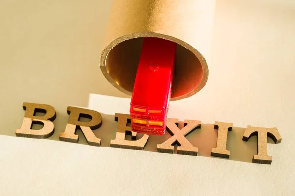 Brexit word abstract in vintage letters, background double decker bus toy model, tunnel — Stock Photo, Image