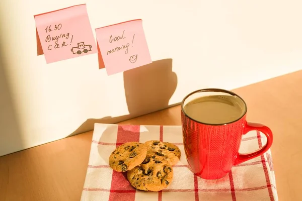 Sticker GOOD MORNING, BUYING CAR on the table at home. Background - tablecloth with cup of coffee and cookies — Stock Photo, Image