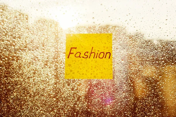 Sticker with text FASHION. Background sunny window with shiny rain drops — Stock Photo, Image