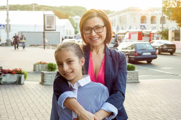 Mamma och hennes dotter är kramar och leende. — Stockfoto