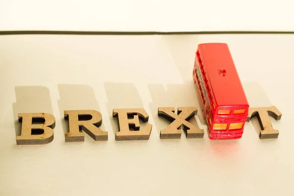 Britain exit from European Union, Brexit word abstract in vintage letters,background double decker bus toy model. — Stock Photo, Image