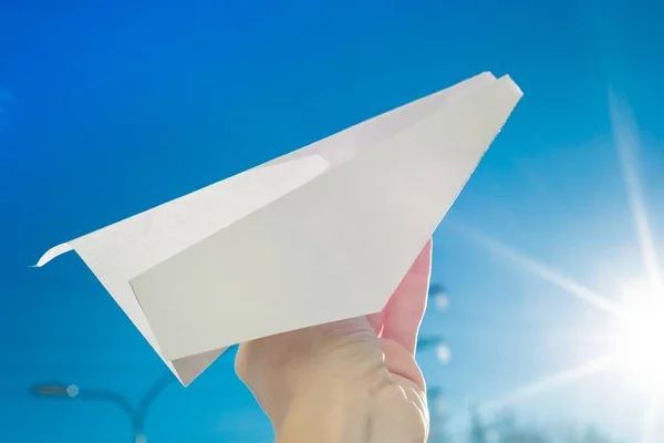 Abstract paper plane, in hand, sky, sun background — Stock Photo, Image