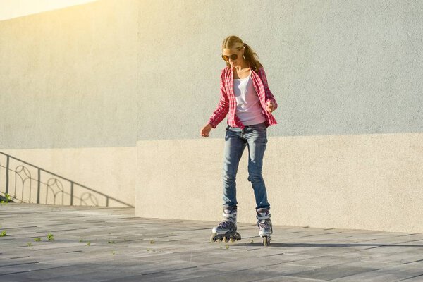 Active sports teen in roller skates on the urban background