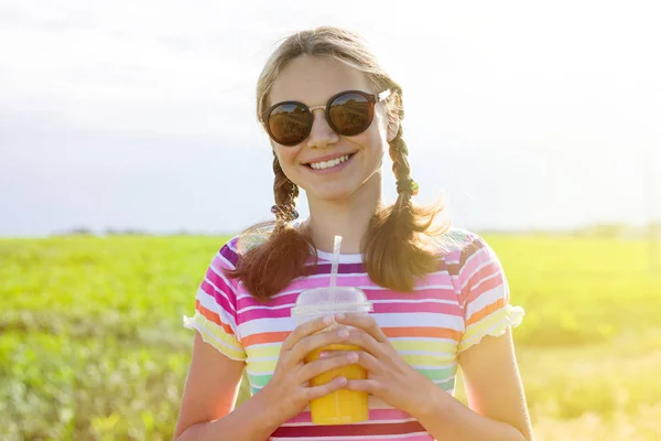愉快的女孩喝橙汁在热的夏天天. — 图库照片