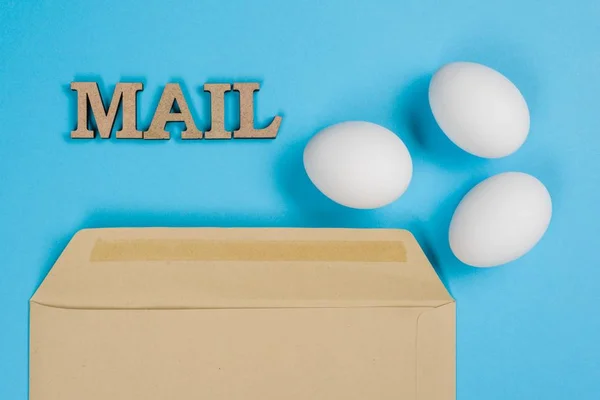 The concept of secure courier service, reliable postal company. Abstract image of eggs in an envelope and the word mail, post. — Stock Photo, Image