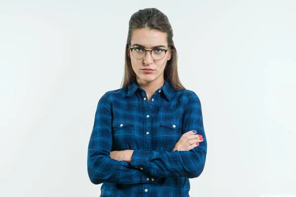 Indoor shot of angry grumpy young woman in glasses over white background — Stock Photo, Image
