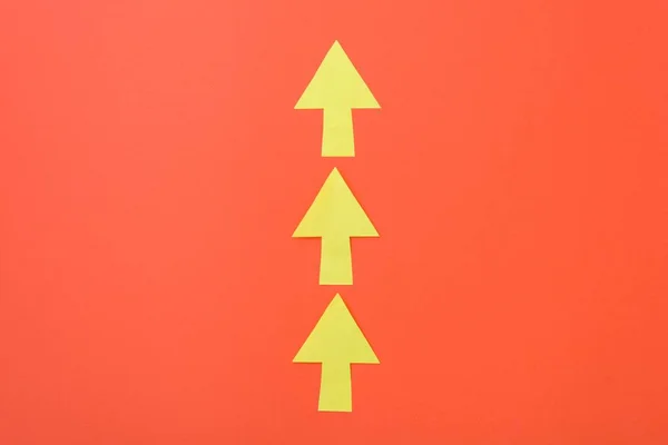 Arrows only forward. Three arrows in one direction. Orange background and bright yellow arrows. — Stock Photo, Image