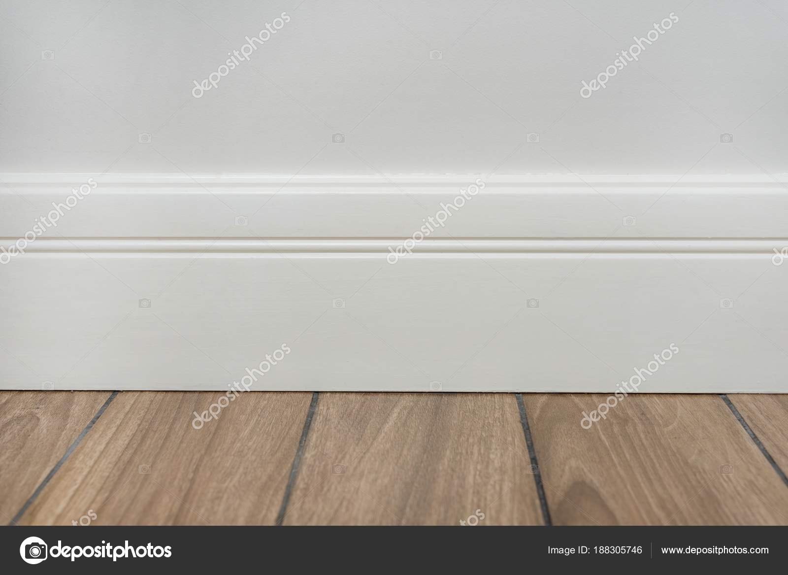 Light Matte Wall White Baseboard And Tiles Immitating Hardwood
