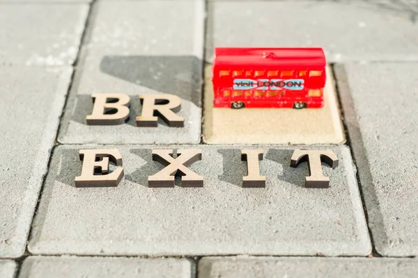 Kyiv, UA, 17.11.2017 Britain exit from European Union, Brexit word abstract in vintage letters,background double decker bus toy model — Stock Photo, Image