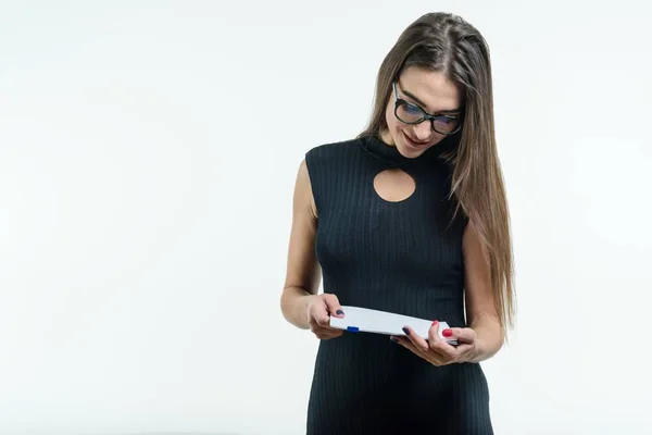 Business woman in glasses black dress reading document. White background, copy space — Stock Photo, Image