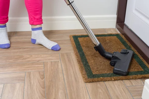 Уборка дома. Женщина чистит пылесосом — стоковое фото