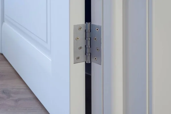 Metal chrome hinged hinges on a white interior door — Stock Photo, Image