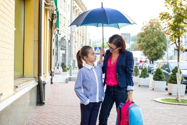 Anne kızı ile konuşuyor. Şehrin bir şemsiye altında arka planı