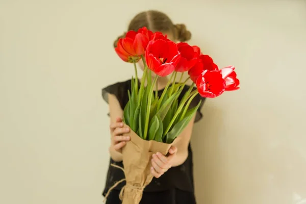 Little child girl holding bouquet of red tulips — Stock Photo, Image