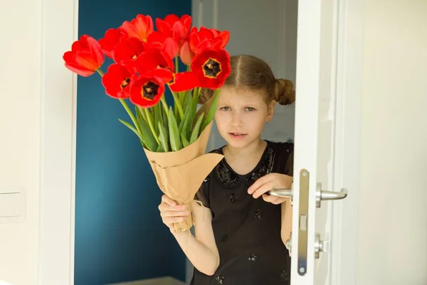 Beautiful little girl holding bouquet of flowers — Stock Photo, Image