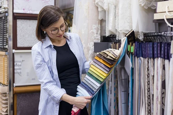 Adult woman chooses fabrics