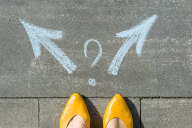 Female legs with 2 arrows and question mark, painted on the asphalt. clipart