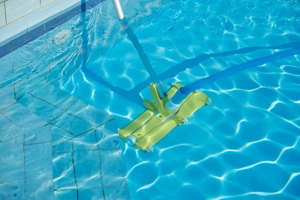 Primer plano de la piscina al aire libre bajo el agua, tubo de vacío de limpieza —  Fotos de Stock