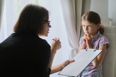 Meeting child girl with school counselor psychotherapist. clipart