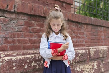 Back to school. Outdoor portrait of beautiful blond girl with backpack