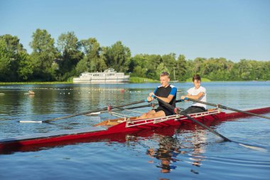 Active healthy lifestyle teens. Boys paddling sport kayak
