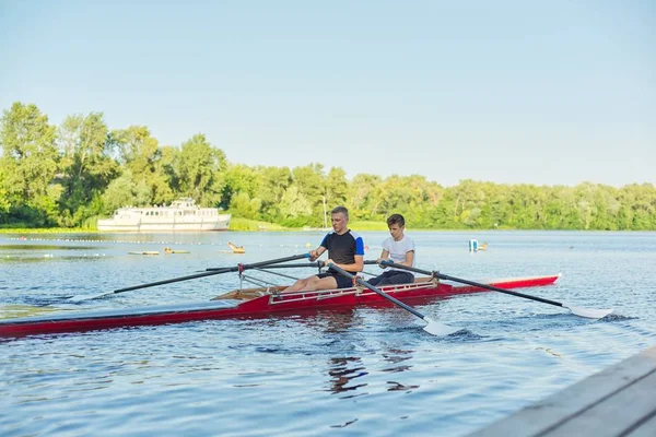 Active healthy lifestyle teens. Boys paddling sport kayak — Stock Photo, Image