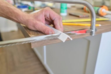 Repair in the house, installation and cutting of wooden painted corners