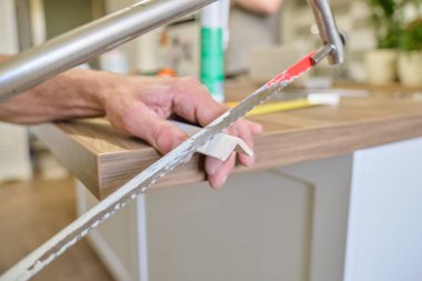 Repair in the house, installation and cutting of wooden painted corners