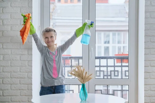 Girl child in gloves with spray detergent with rag cleaning windows — Stock Photo, Image