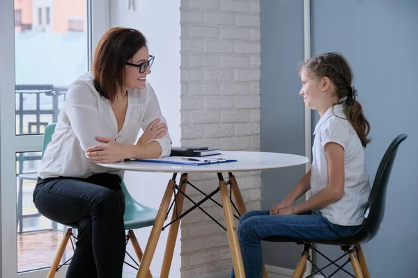 Communication session of school psychologist and girl 9, 10 years. Child tells psychotherapist his experiences, mental health of children