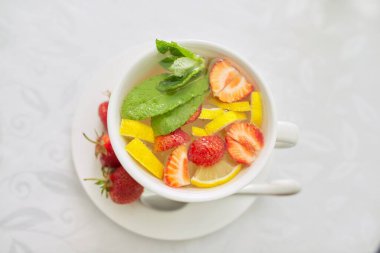 Masanın üzerinde nane aromalı çilek çayı.