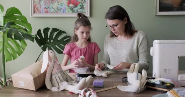 Mutter und Tochter nähen gemeinsam Hasenpuppe, Hobbys und Freizeit zu Hause — Stockvideo