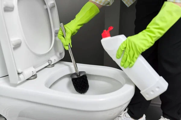 Housewife washing and disinfecting toilet, in gloves with detergent and brush — Stock Photo, Image