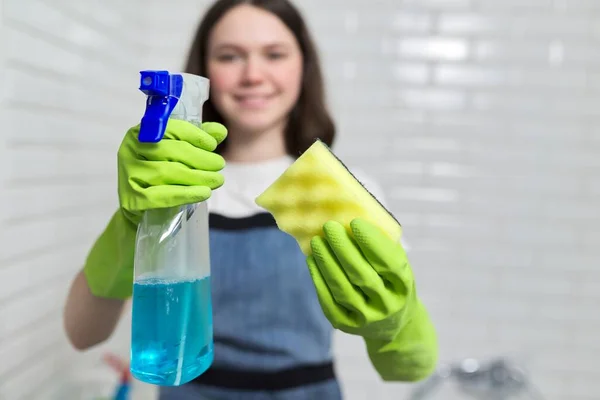 Portrait of girl doing cleaning in bathroom