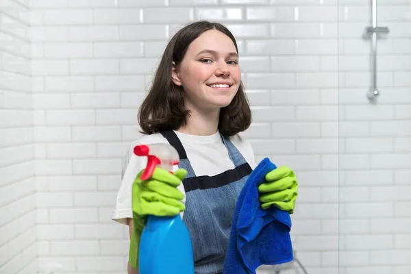 Portrait of girl doing cleaning in bathroom