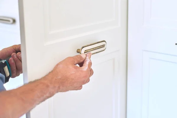 Installation of new cabinet, handyman sets door handles — Stock Photo, Image