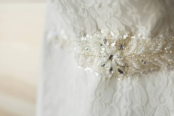 Close- up of a beaded decoration on a white wedding dress. — Stock Photo, Image