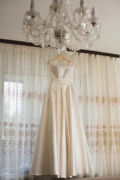 Robe de mariée à la maison sur un cintre . — Photo