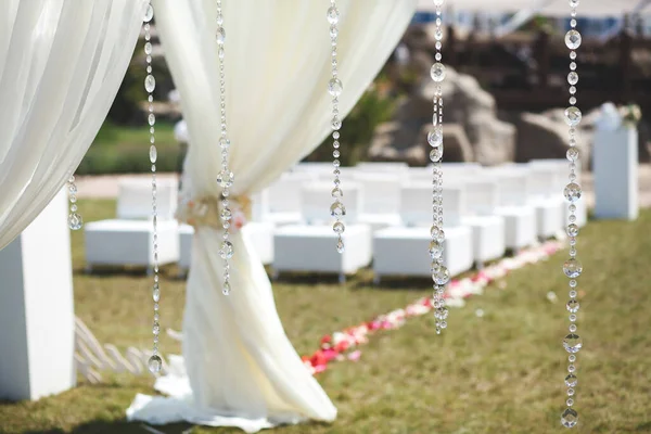 White wedding tent for the ceremony outdoors. Arch. Chairs.