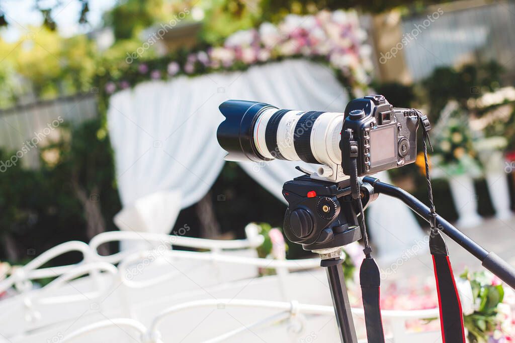 The work of photographer and videographer at the wedding. The camera and lens.