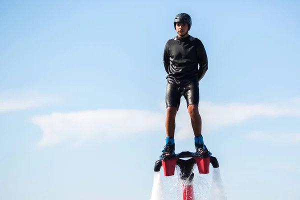 Silhouette of a fly board rider at sea.