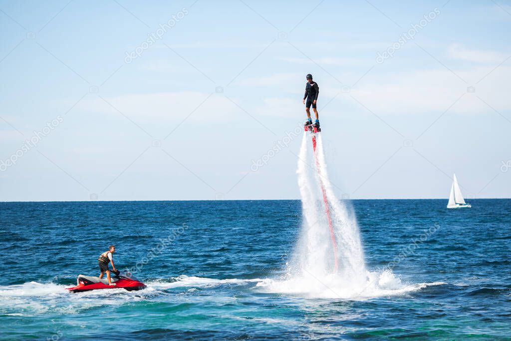 Silhouette of a fly board rider at sea