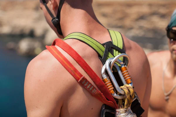 Rope jumping off a cliff with a rope in the water. The ocean. Sea. Mountain