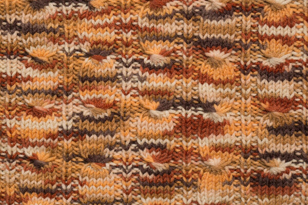 knitted fabric background texture in yellow. Ornament.