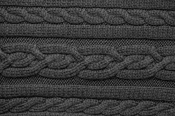 Knitted wool fabric background texture black. Ornament. — Stock Photo, Image