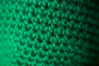 Arkaplan olarak yeşil örülmüş yün dokusu kullanılabilir.